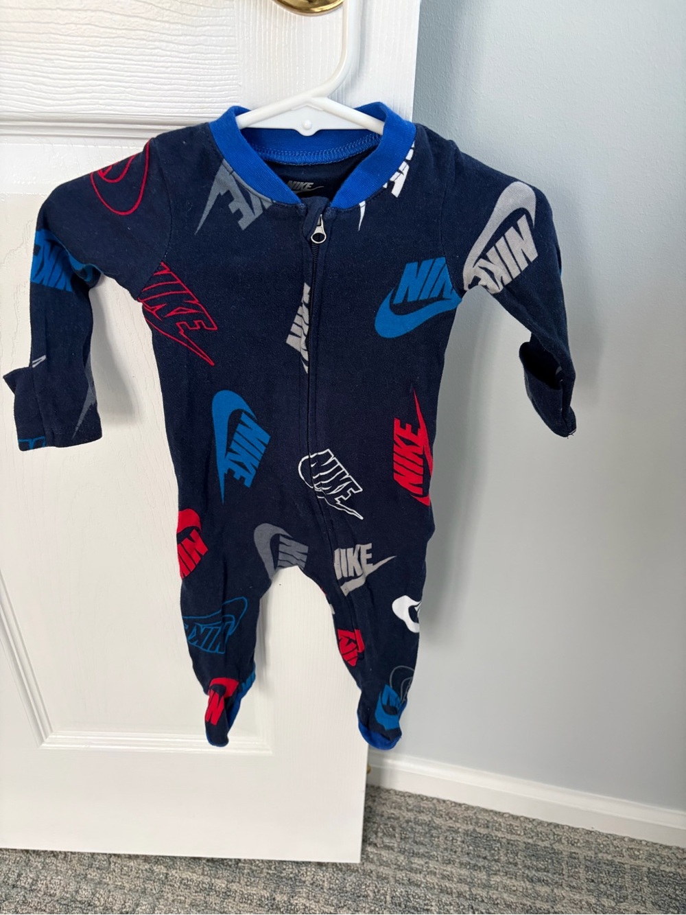 Nike Navy Blue Footed Baby One-Piece with Red, Blue, and Gray Logos